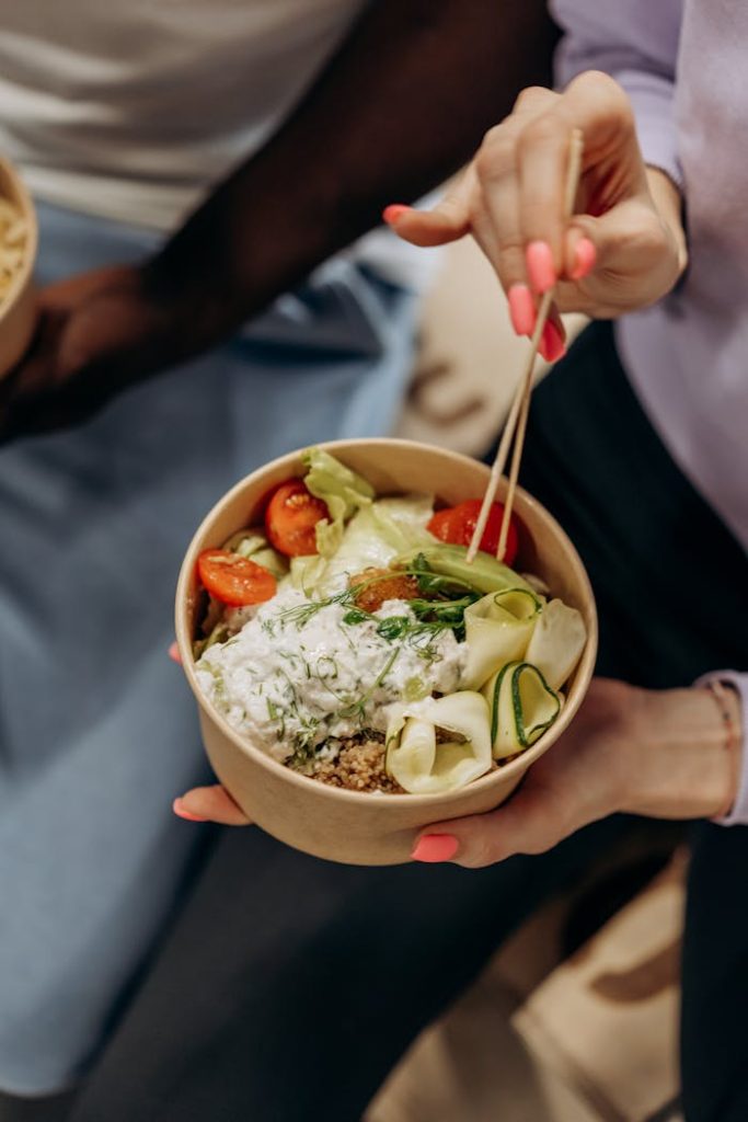 Person Holding A Bowl With Vegetable Salad